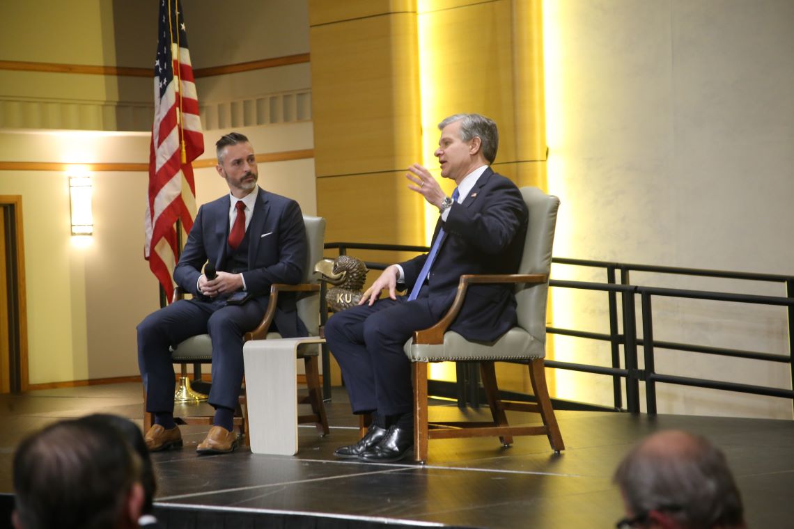"FBI Director Christopher Wray (right) speaking answering a question during a panel"