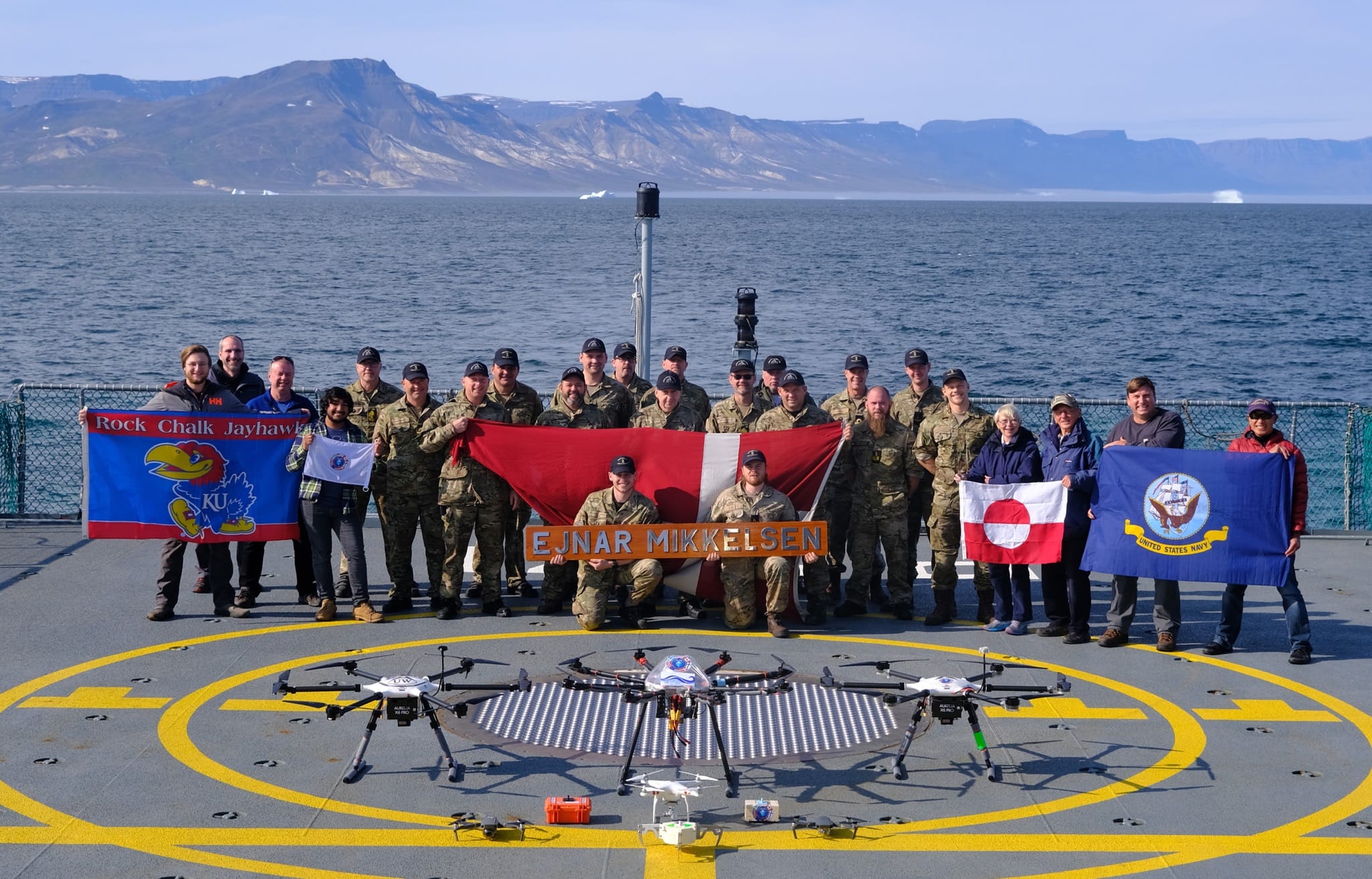 Three research teams stand aboard the Danish Navy vessel in Disko Bay